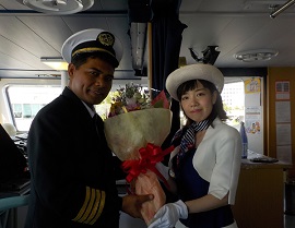 the scene where the captain is receiving a bouquet of flowers during the welcome ceremony