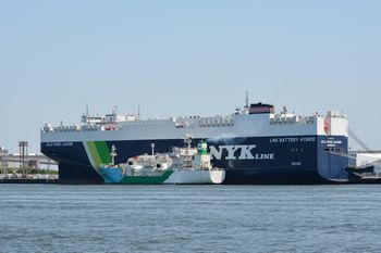 An LNG-fueled pure car and truck carrier receiving LNG fuel from an LNG bunkering ship
